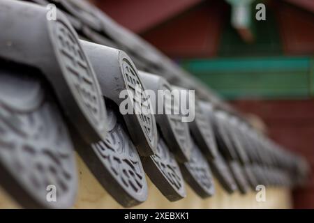 Traditional Korean wall with ancient patterns and symbols at Gyeongbokgung Palace in Seoul, South Korea, in selective focus. Stock Photo