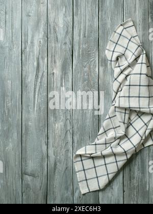 Gray wooden table with kitchen napkin, flat lay Stock Photo