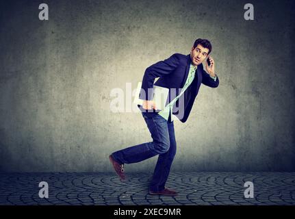 Business man on a phone running late to work Stock Photo