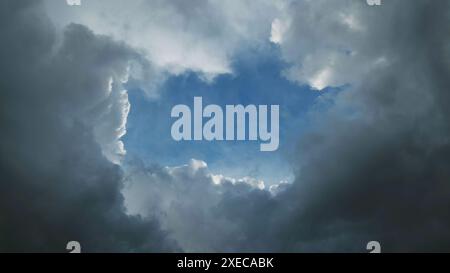 Storm clouds and hole with blue sky Stock Photo