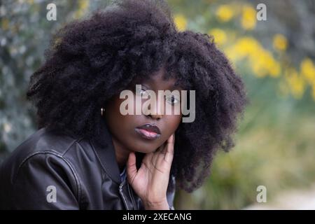 Thoughtful African American Woman with Stylish Afro in Autumn Setting Stock Photo