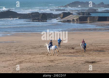 Horse riders on Summerleaze Beach in Bude in Bude in Cornwall in the UK. Stock Photo