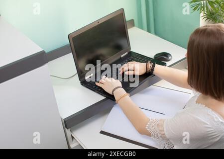 A young girl sits over the lessons given by her teacher Stock Photo - Alamy