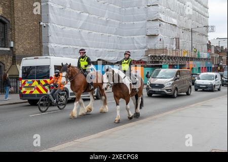 London, UK - March 21, 2024 :  London Metropolitan Police officers on horses on tower bridge. Stock Photo