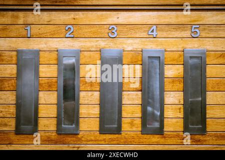Five letter box slots in a row Stock Photo