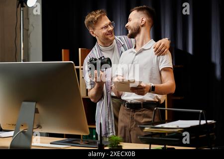 Two men collaborate on computer projects in modern office setting. Stock Photo