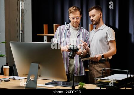 Two men engrossed in a computer screen, collaborating in a cozy office setting. Stock Photo