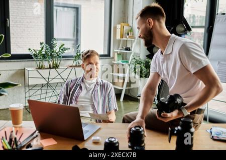 Two loving men in front of a laptop computer, engaging in work. Stock Photo