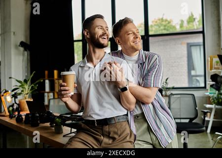 Two men, one in a suit and one in casual clothes, standing together in an office. Stock Photo