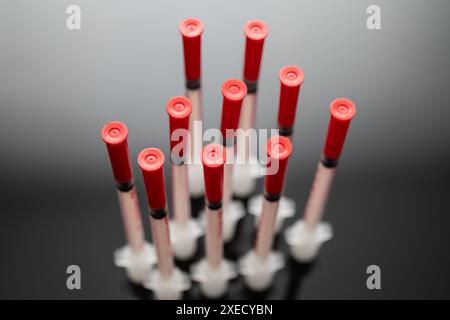 Close-up View of Multiple Blood Sample Tubes on a Reflective Dark Surface, Medical Research and Testing Concept, insuline injection, insuline syringe Stock Photo