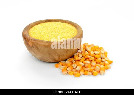 Corn meal polenta in wooden bowl and dry grains isolated on white background. Stock Photo