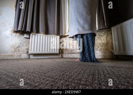 Terrible damp and mold on the walls and ceiling of a rented house covering the front room. Stock Photo