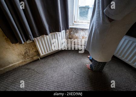 Terrible damp and mold on the walls and ceiling of a rented house covering the front room. Stock Photo