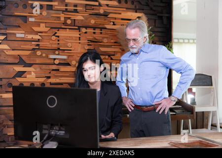 A businessmen and businesswomen working on computer in a modern office room Stock Photo