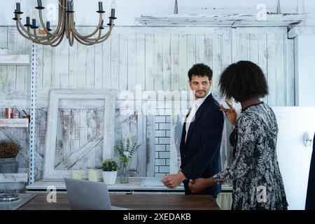 In a modern clothes fashion room, a clothing designer or tailor allows buyers to try on molded outfits before sewing them. Stock Photo