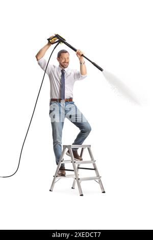 Man climbing a ladder and using a high pressure washer machine isolated on white background Stock Photo
