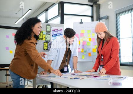 Multiethnic young business people working together in modern office, Collaborate to designing an application for use on the inte Stock Photo
