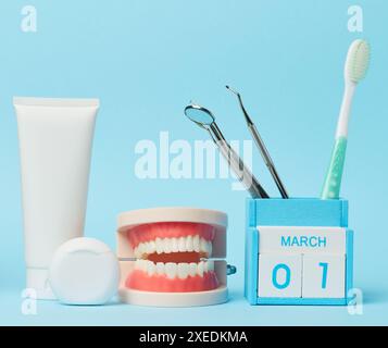 Plastic bottle with mouthwash, dentist medical instruments on blue background Stock Photo