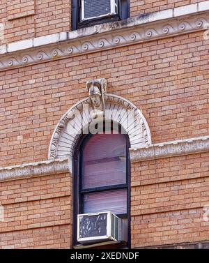 NYC Chinatown: 116 Mott Street, a six-story walk-up apartment building, has a rounded corner and white terra cotta details on its orange brick façade. Stock Photo