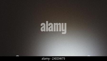 Textured background with a grainy effect transitioning from dark to light Stock Photo