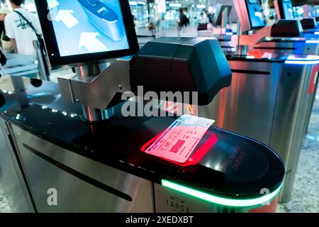 A ticket with a boarding pass bar code on the boarding pass scanner to read and validate the flight information, Istanbul Airport (IST), Turkey Stock Photo