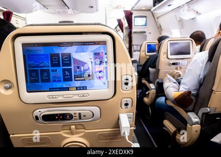 Main menu in Personal television, PTV in front of an airplane seat  Boeing 787-10 Etihad aiways Stock Photo