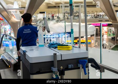 Working female staff cleaning windows in Zayed International Airport, Abu Dhabi, UAE, United Arab Emirates, Asia Stock Photo