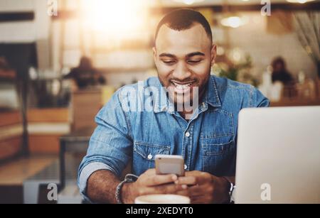 Man, cafe and happy typing on smartphone, smiling and message notification on mobile app with online searching. Communication, freelance writer and Stock Photo