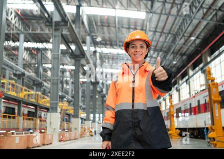 Portrait of a young female engineer standing in the skytrain repair station. Stock Photo
