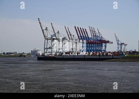 Dockside cranes in the port of Hamburg, Germany. On the left is cruise ship Aida Perla. Stock Photo