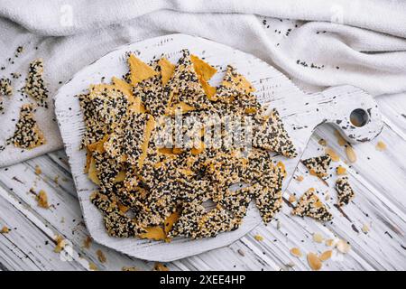 Salted tortilla chips triangle with chia seeds on top view Stock Photo