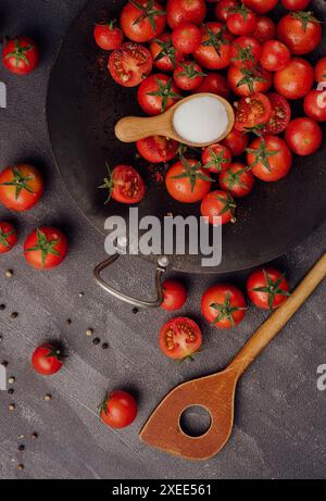 Cherry tomatoes on against black stone surface Stock Photo