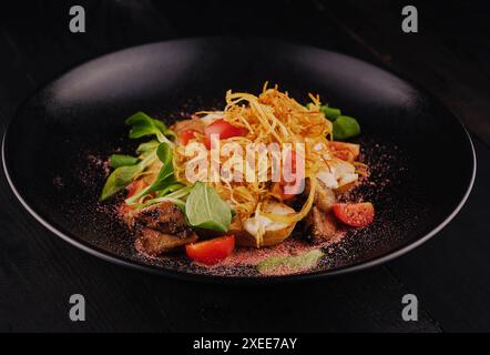 Traditional dry aged sliced roast beef with fried onion chips Stock Photo