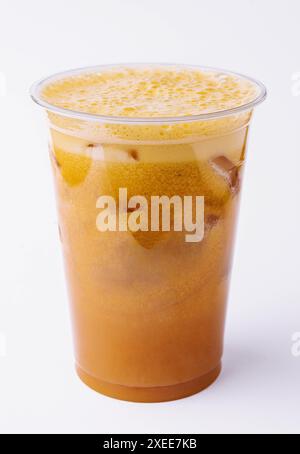 Iced caramel coffee covered with whipped cream in plastic glass Stock Photo