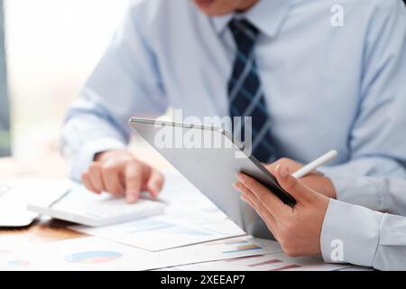 Businessman Analyzing Data on Digital Tablet Stock Photo