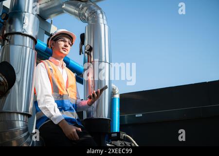 Engineers inspect the completed air conditioning and water systems to continue verifying their functionality. Stock Photo