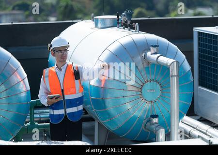 Engineers inspect the completed air conditioning and water systems to continue verifying their functionality. Stock Photo