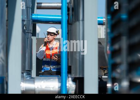 Engineers inspect the completed air conditioning and water systems to continue verifying their functionality. Stock Photo