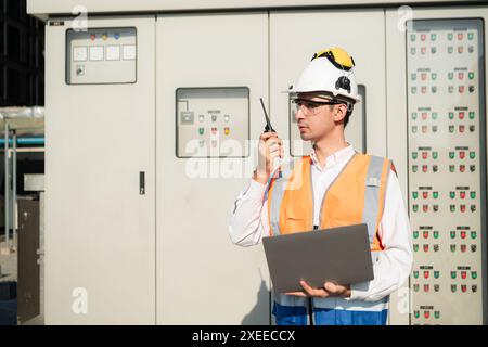 Before proceeding with the testing, Electrical engineer inspects the installed control panel. Stock Photo