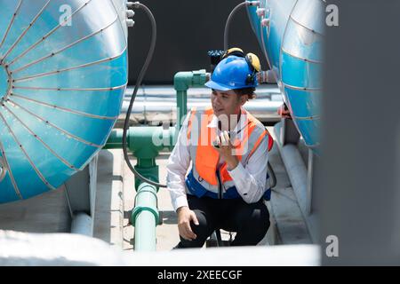 Engineers inspect the completed air conditioning and water systems to continue verifying their functionality. Stock Photo