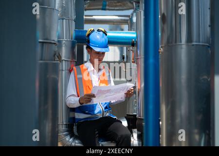 Engineers inspect the completed air conditioning and water systems to continue verifying their functionality. Stock Photo