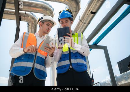 Engineers and technicians Inspect the completed air conditioning and water systems to continue verifying their functionality. Stock Photo
