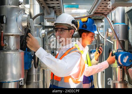 Engineers and technicians Inspect the completed air conditioning and water systems to continue verifying their functionality. Stock Photo