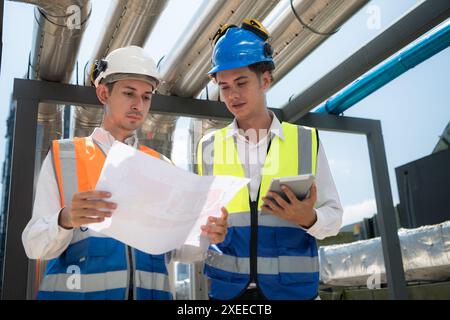 Engineers and technicians Inspect the completed air conditioning and water systems to continue verifying their functionality. Stock Photo