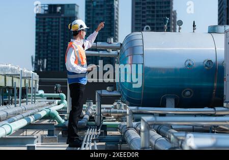 Engineers inspect the completed air conditioning and water systems to continue verifying their functionality. Stock Photo