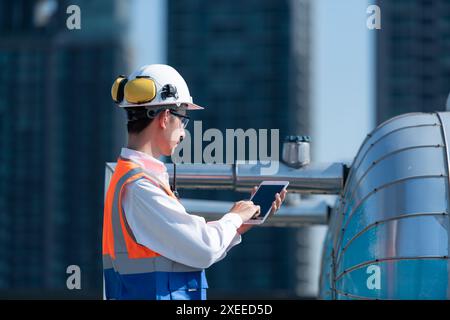 Engineers inspect the completed air conditioning and water systems to continue verifying their functionality. Stock Photo