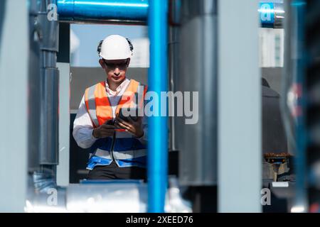 Engineers inspect the completed air conditioning and water systems to continue verifying their functionality. Stock Photo