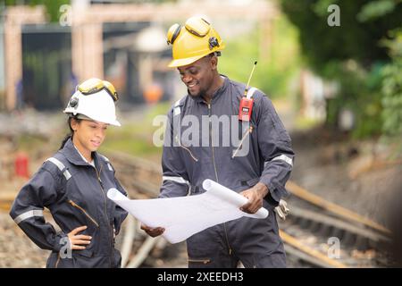 Railway technicians and engineers, Working on the train tracks at train station Stock Photo