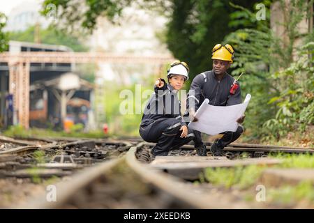 Railway technicians and engineers, Working on the train tracks at train station Stock Photo