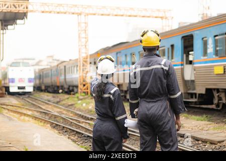 Railway technicians and engineers, Working on the train tracks at train station Stock Photo